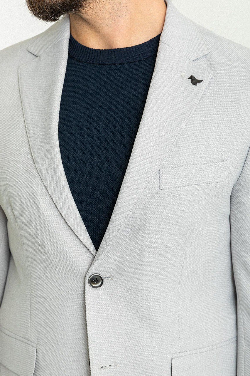 Man wearing a Silver Lining Casual Blazer with a sharp pointed collar, flap pockets, and a double-button closure, perfect for both formal and casual occasions.