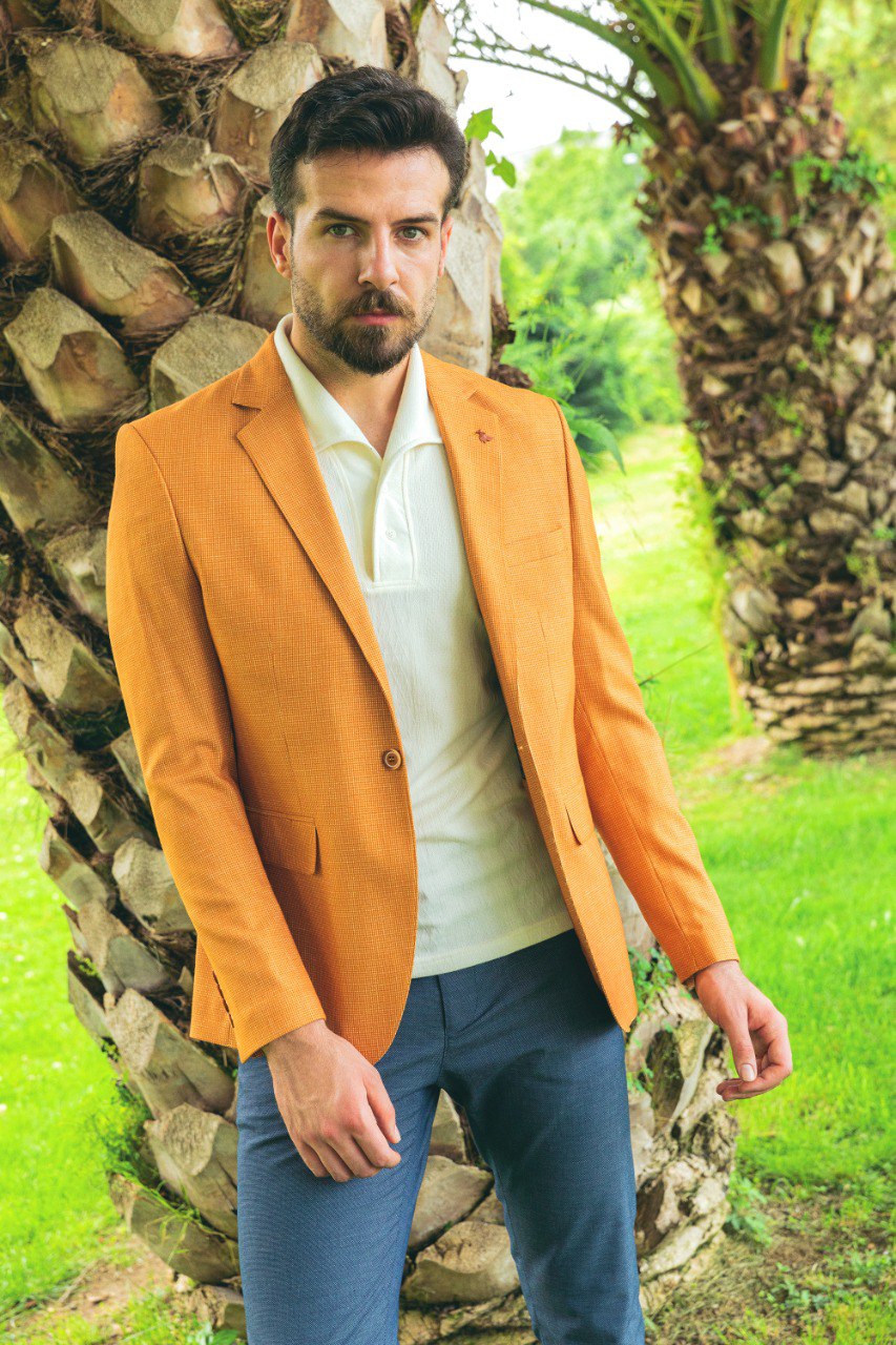 Man wearing a Golden Hour Blazer with a pointed collar, flap pockets, and a slim fit, perfect for summer weddings and casual outings.