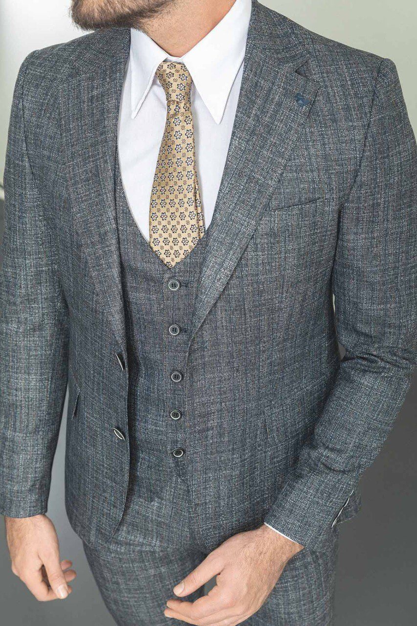 Man in a slim-fit gray 3-piece suit, showcasing elegant men's formalwear.