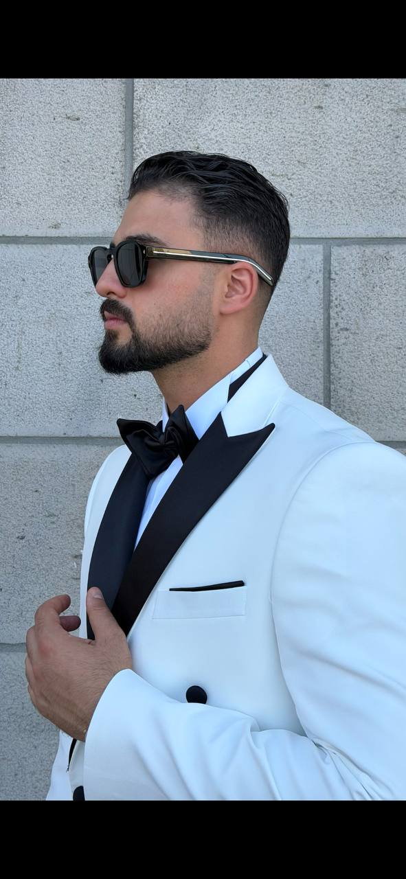 Men's white tuxedo with contrasting black peak lapel side detail