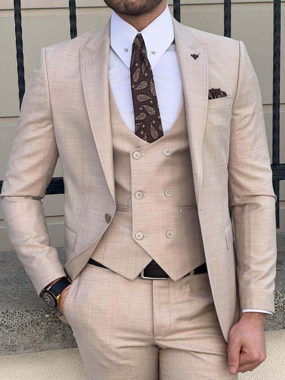 A model showcasing beige suit for men.
