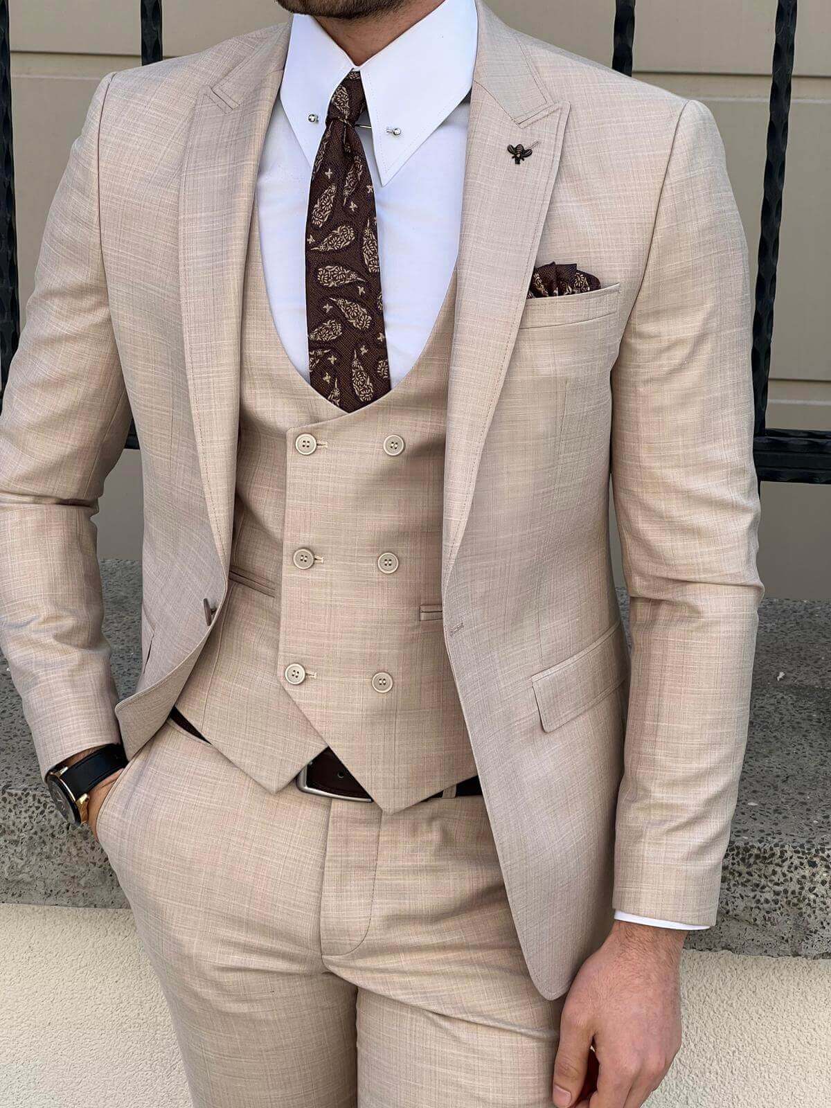 A model showcasing beige suit for men.