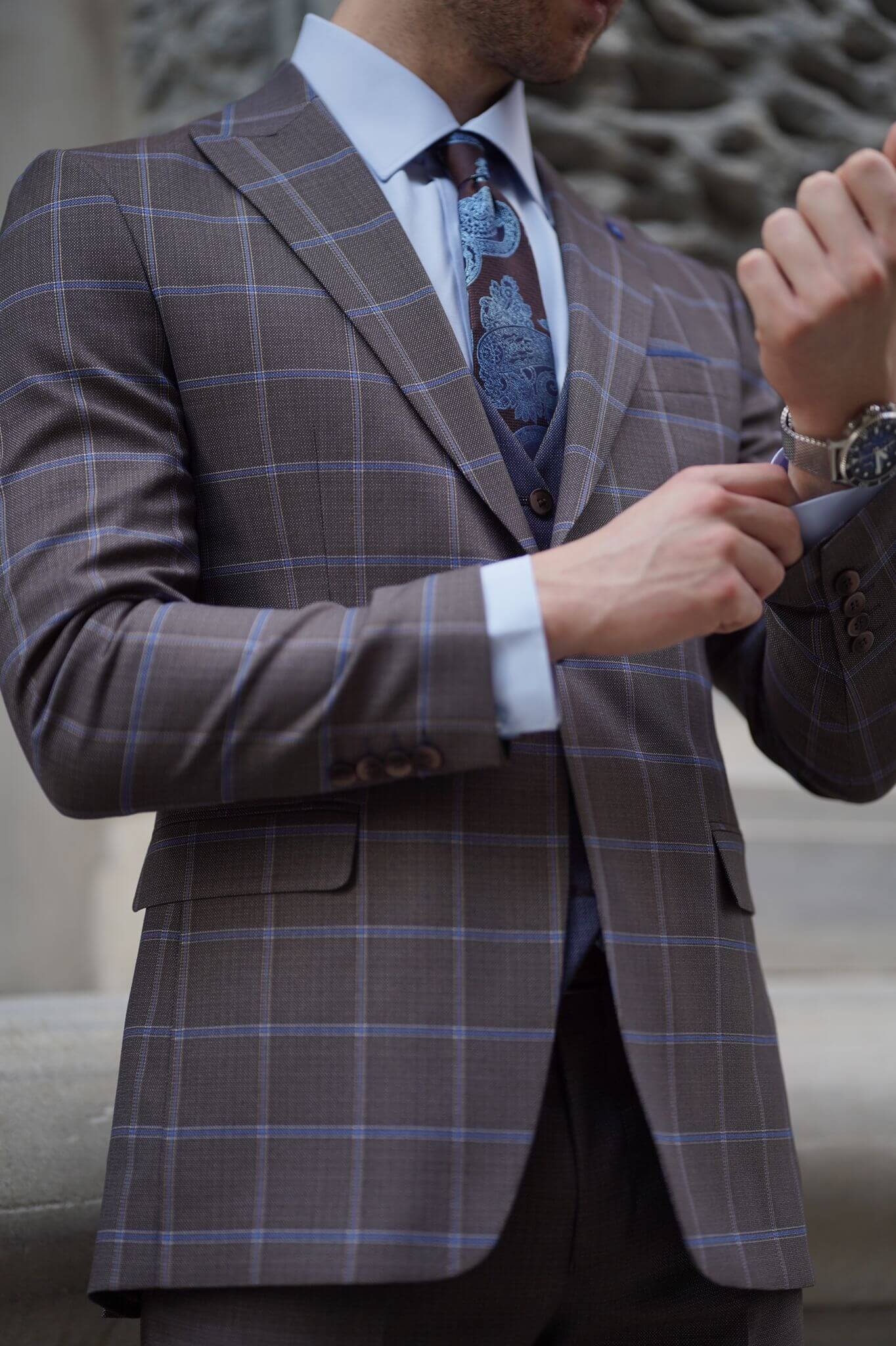 A Slim-Fit Plaid Brown Wool Combination Suit on display.